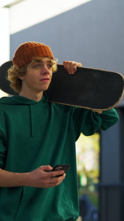 Youthful Energy with Skateboard and Beanie Under City Lights