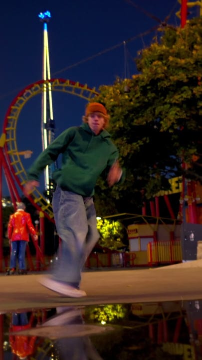 Street Dancer Moves Under Amusement Park Lights