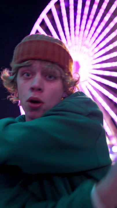 Street Dancer Moves Under Neon Wheel Lights