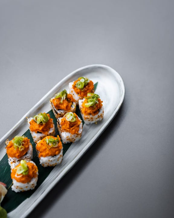Elegant Sushi Platter With Vibrant Toppings On Display