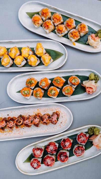 Vibrant Sushi Creations Displayed On Elegant Serving Platters