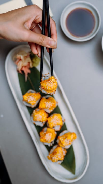 Chopsticks Elevate A Burst Of Sushi Delight