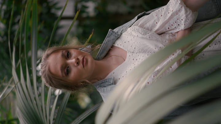 Contemplative Moment Among Lush Tropical Foliage