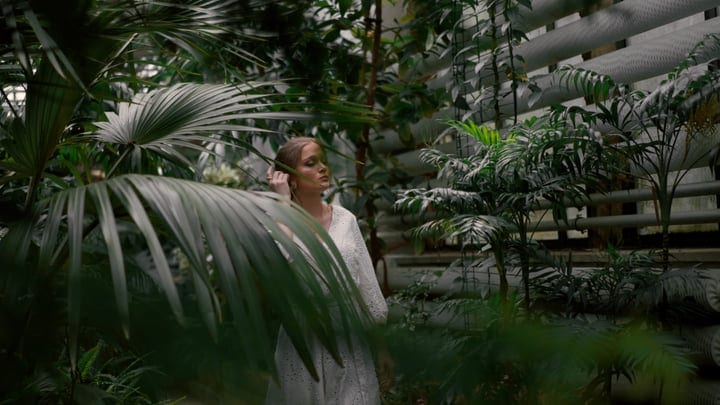 Serenity Found: Woman Wanders Through Lush Tropical Garden