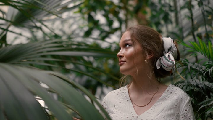 Young Woman Embraces Tranquility In Lush Tropical Oasis