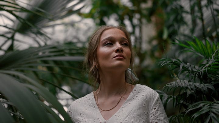 A Woman's Contemplative Moment In A Tropical Oasis