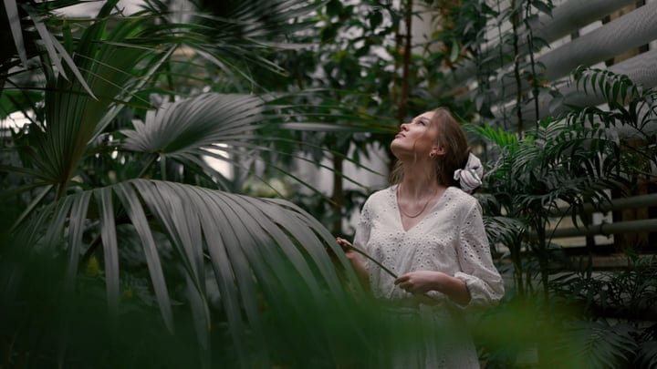 A Woman Finds Solace In Lush Tropical Garden