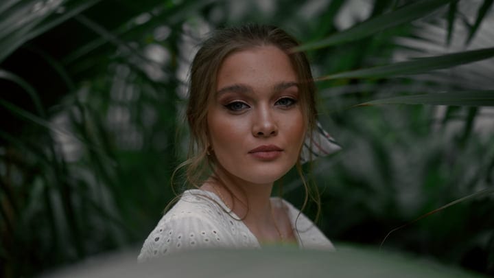 Gazing Through Lush Greenery In A Tropical Oasis
