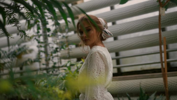 Serene Woman Embraces Nature In Tropical Garden