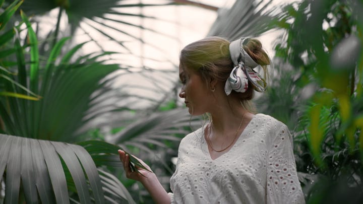 A Woman Embraces Nature in a Lush Tropical Escape