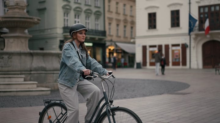 Confident Woman Pedals Through European City Streets