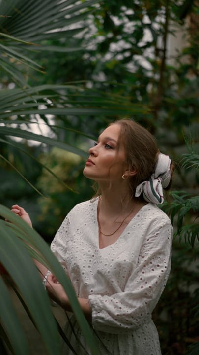 Woman in White Dress Embracing Tropical Serenity