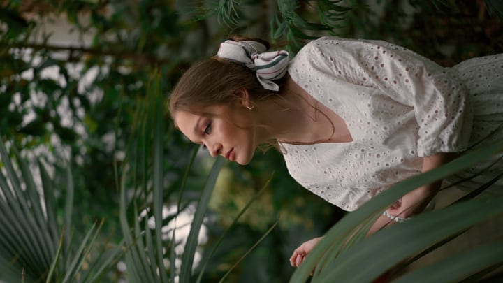 Curious Woman Exploring Verdant Tropical Foliage