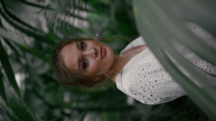Serene Woman Enjoys Peaceful Moment In Tropical Garden