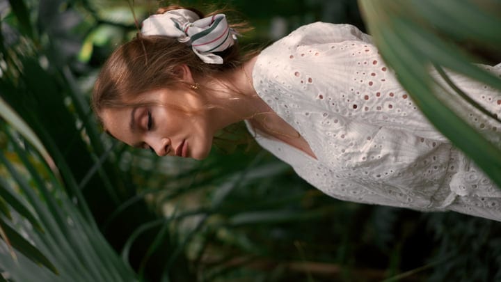 Serene Woman Embracing Nature In A Tropical Hideaway