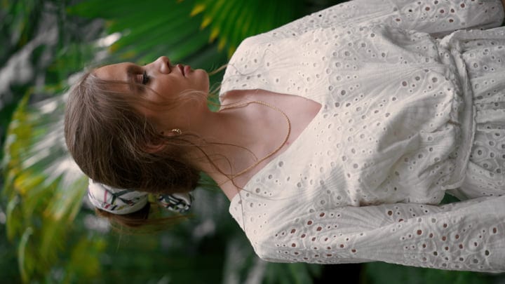 Elegant Woman Enjoys Tranquility of Lush Tropical Garden