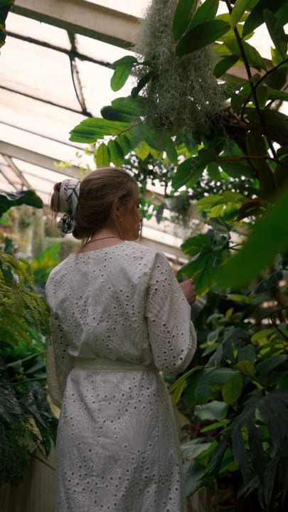 Woman Embraces Tranquility in Lush Tropical Garden