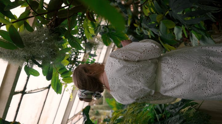 A Woman Immersed In Lush Tropical Foliage
