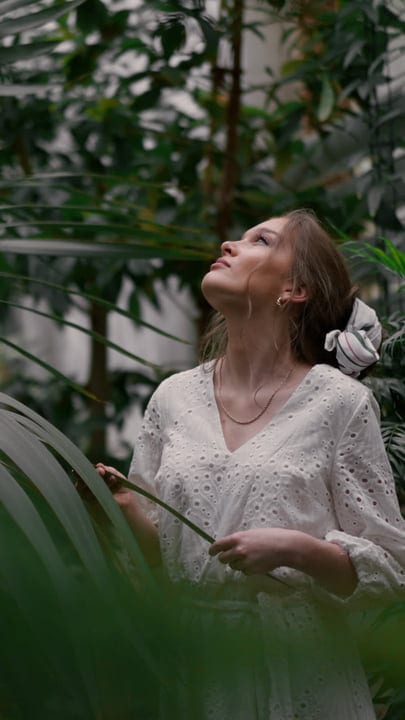 Woman Embraces Serenity in Lush Tropical Garden
