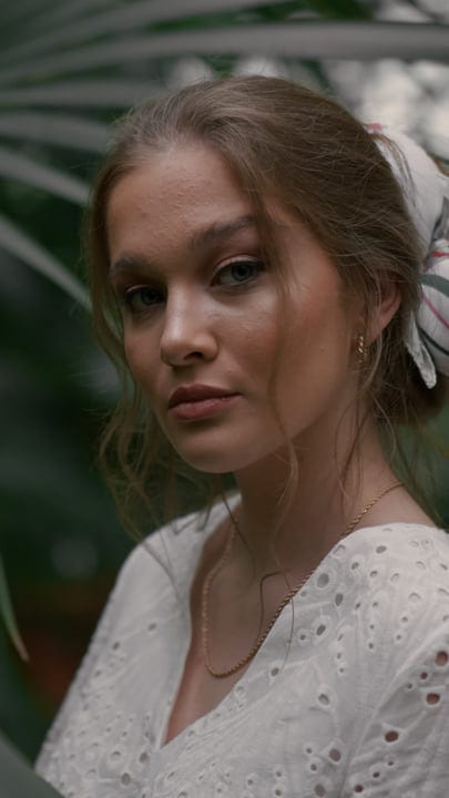 Contemplative Woman in Lush Tropical Garden Setting