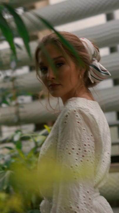 A Woman Finds Serenity In A Lush Greenhouse Retreat