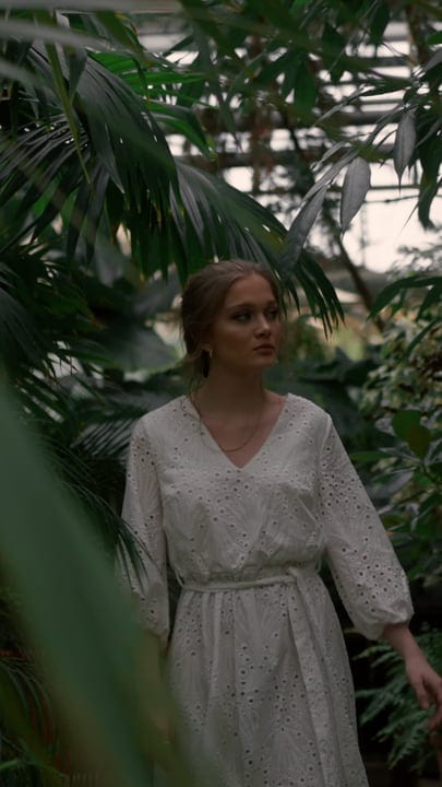 A Woman's Quiet Stroll Through Lush Greenery