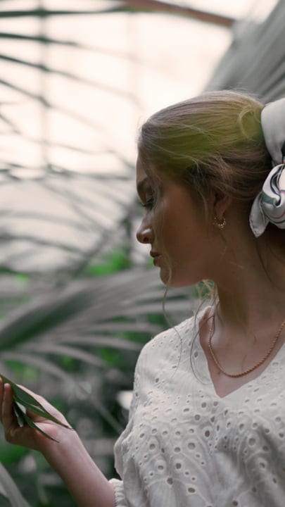 Woman Contemplates Nature's Beauty in Tropical Sanctuary