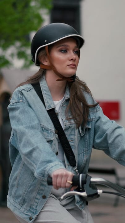Young Woman Rides Confidently Through Urban Streets
