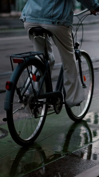 Pedaling Through Rain-Kissed Streets In Denim