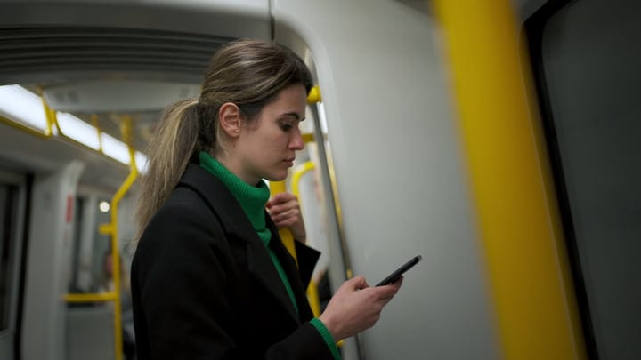 Focused Businesswoman Navigates Copenhagen Transit With Determination