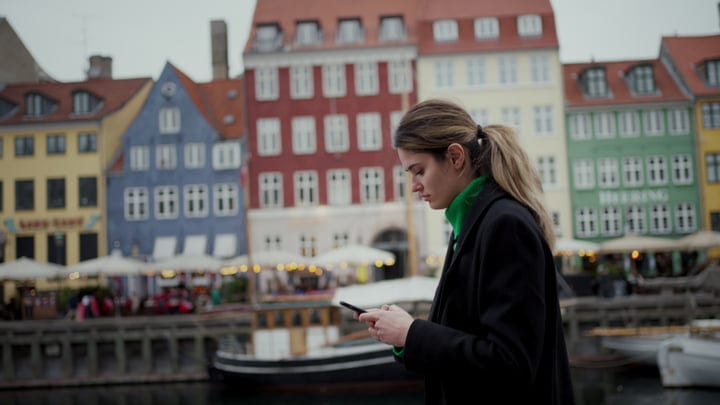 Focused Businesswoman Checks Her Phone In Copenhagen