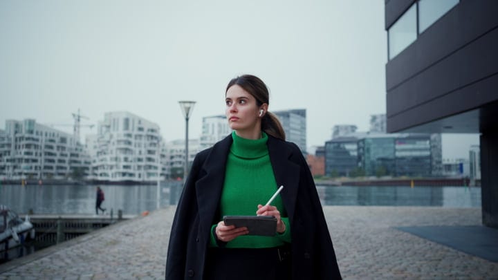 Focused Businesswoman Navigating Copenhagen's Urban Landscape