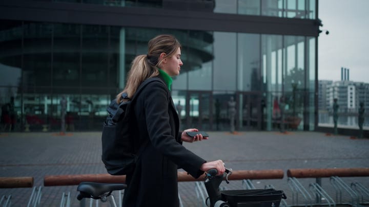 Confident Businesswoman Navigates Copenhagen's Busy Streets