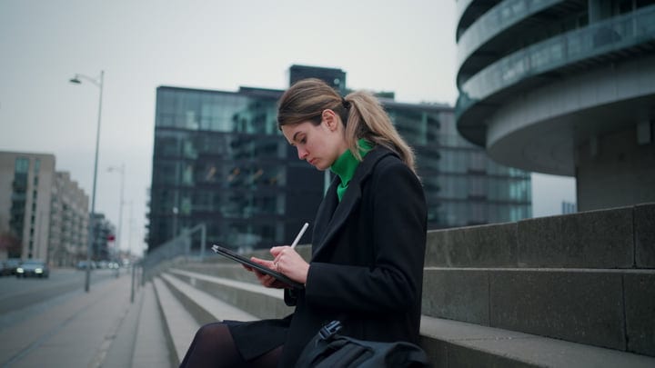 Focused Businesswoman Engages with Digital Tablet in Copenhagen