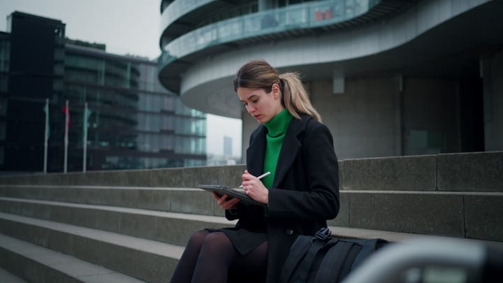 Focused Businesswoman Engages With Technology Outdoors In Copenhagen