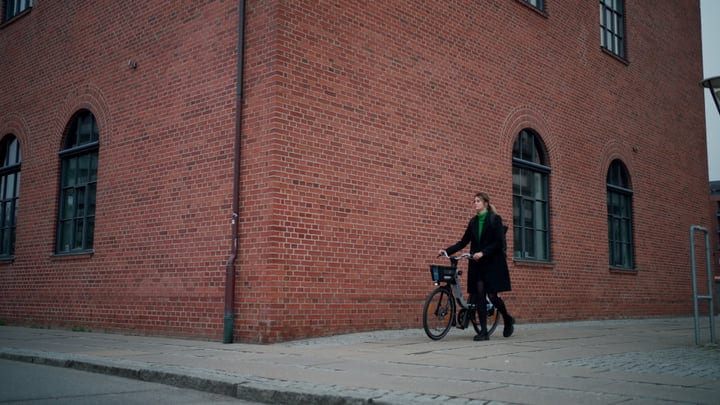 Empowered Woman Navigates Copenhagen Streets on Bicycle
