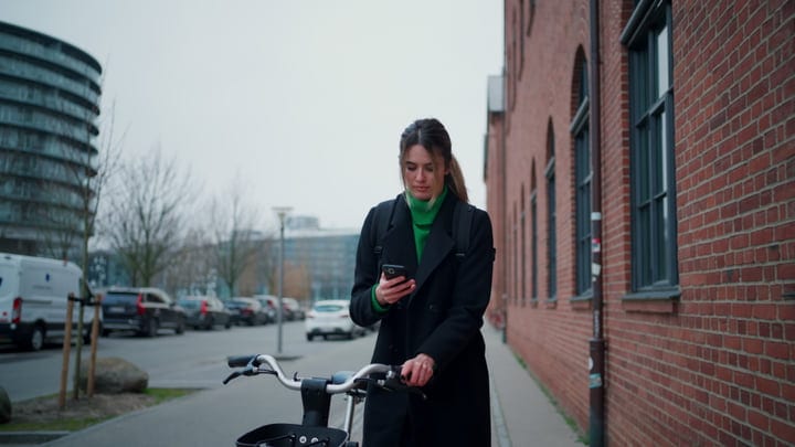 Businesswoman Balances Work And Life On Copenhagen Street