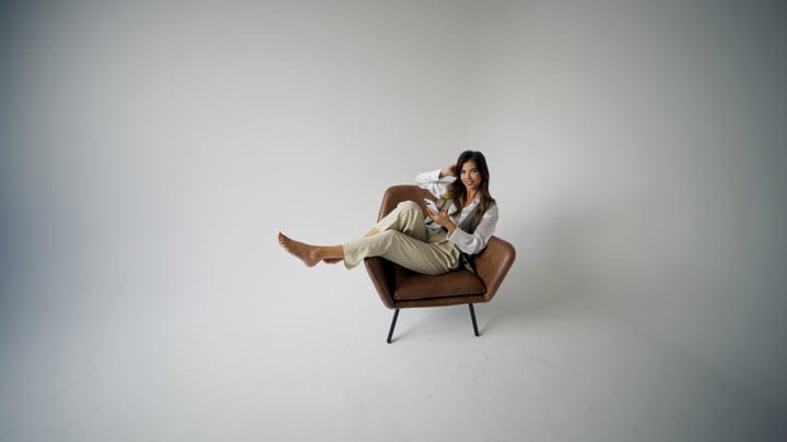 Casual Elegance With A Relaxed Pose In Studio Setting