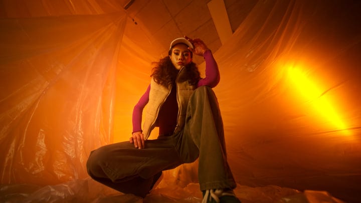 Vibrant Fashion Moment in a Warm Studio Glow