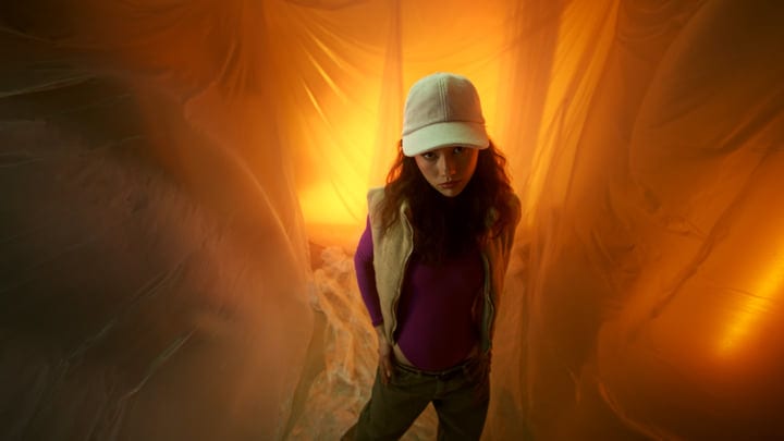 Young Woman Embracing Warm Tones In Studio Setting