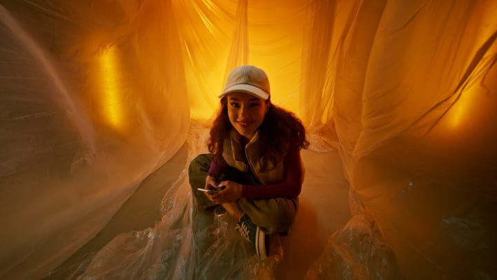 Young Woman Embracing Colorful Fashion In Studio Glow