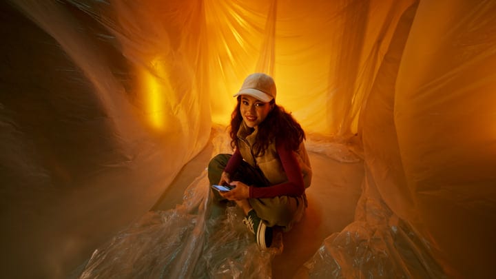 Warm Amber Glow Envelops Young Woman in Studio Setting