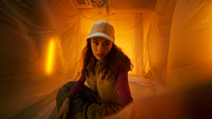 Warm Glow Envelops Model In Fashionable Studio Setting