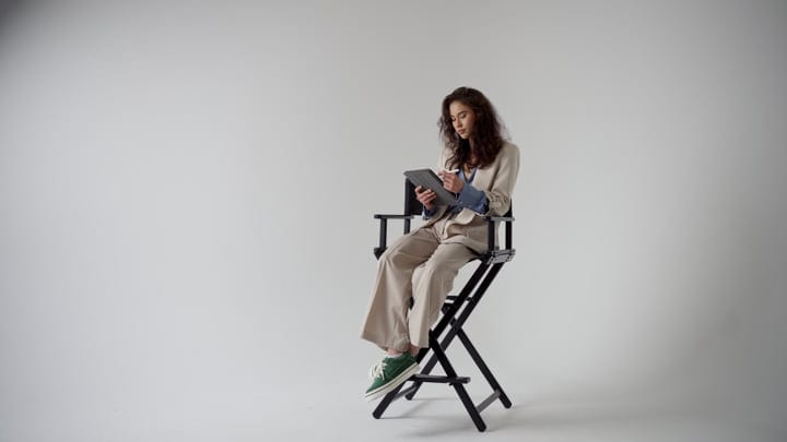 Young Woman Engages With Digital Tablet In Studio Setting
