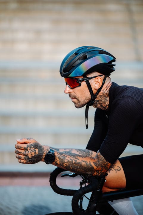 Tattooed Cyclist Rides Through the City Streets