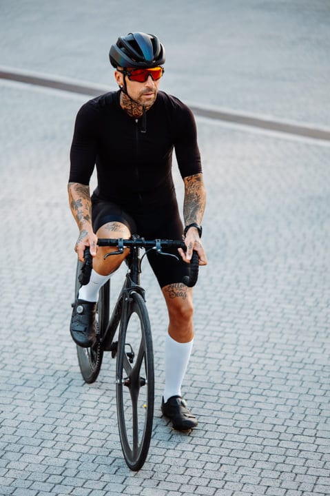 Tattooed Cyclist Navigates Urban Streets In Style