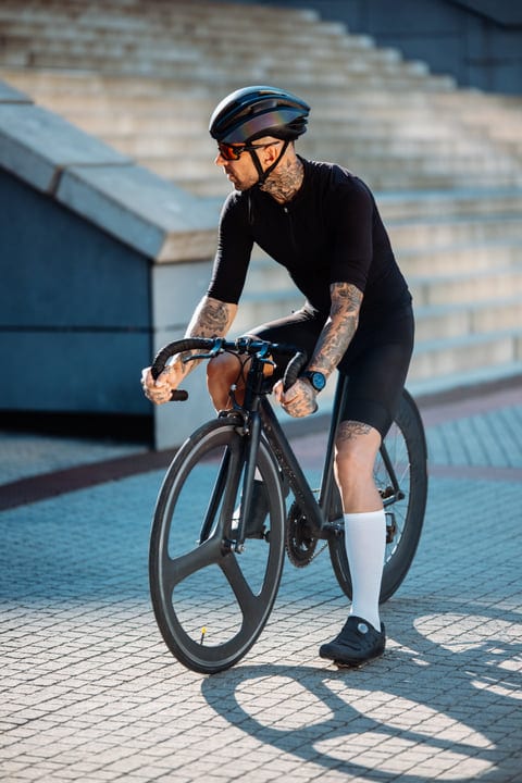 Tattooed Cyclist Navigates Urban Streets With Style