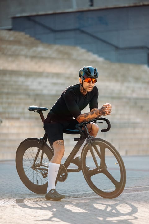 Tattooed Cyclist Embraces the Urban City Ride