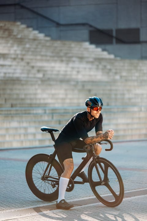 Urban Cyclist Embraces Morning Ride Through City Streets