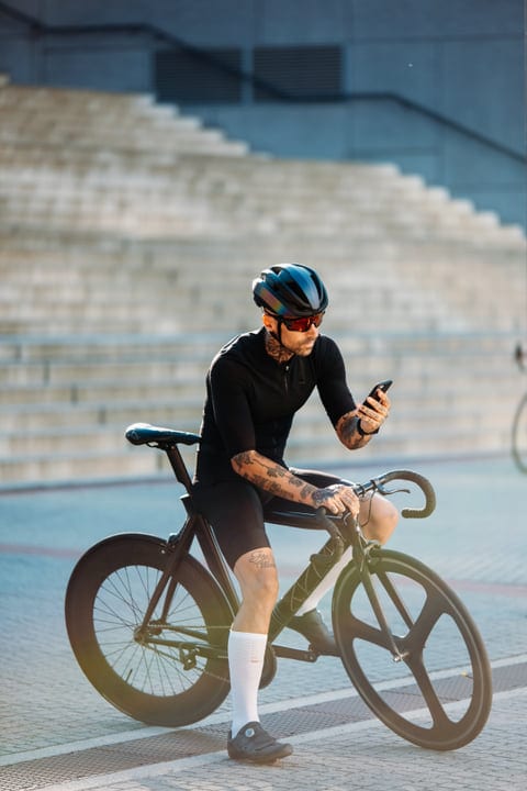 Urban Cyclist Takes A Break To Check Messages